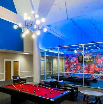 Game lounge featuring billiards, shuffleboard & ping pong
